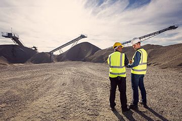 Two men talking at mining site